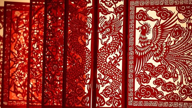 Chinese paper cutting art featuring a dragon and phoenix amidst clouds, displayed in vertical panels.