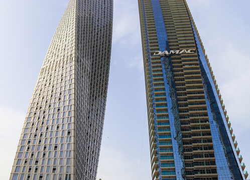 Dubai, United Arab Emirates - 24. September 2024: Tall modern DAMAC skyscrapers reaching into clear Dubai sky