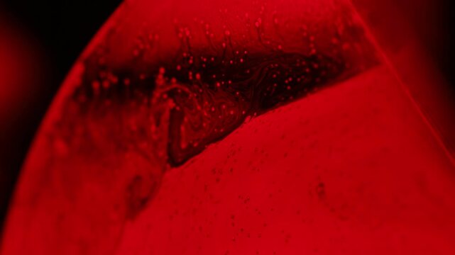 Red psychedelic fluid abstraction, glowing liquid background, bubbles in macro, connection of bubbles in macro, iridescent effect