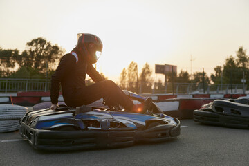 A thrilling go-kart racing scene with a racer preparing to take off on a kart track