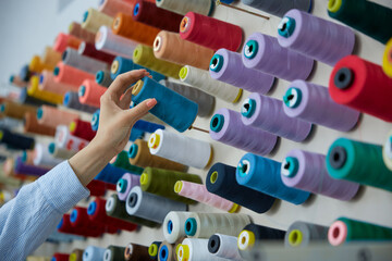 Vibrant and colorful threads organized on display in a charming sewing studio space