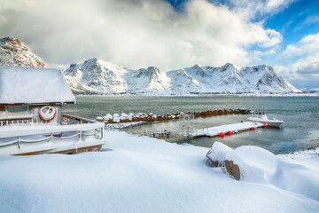 Amazing winter scenery with wooden houses in small fishing village and snowy  mountain peaks near Valberg.