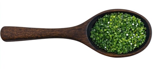 A wooden spoon filled with green seasoning viewed from above on a white background