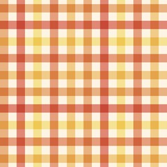 Seamless gingham pattern in warm autumn colors of red, orange, yellow, and cream. 