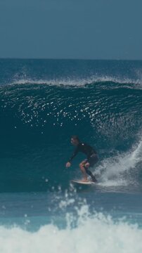 Surfer Powering Through Steep Barreling Wave, Explosive Top Turn And Heavy Spray, Performance Stance On Board,vertical video
