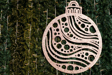 Decorative Christmas ornament with intricate patterns hangs on Christmas tree outdoors