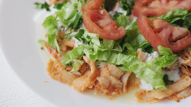 Close-Up of Chicken Kapsalon with Turkish Doner on White Plate