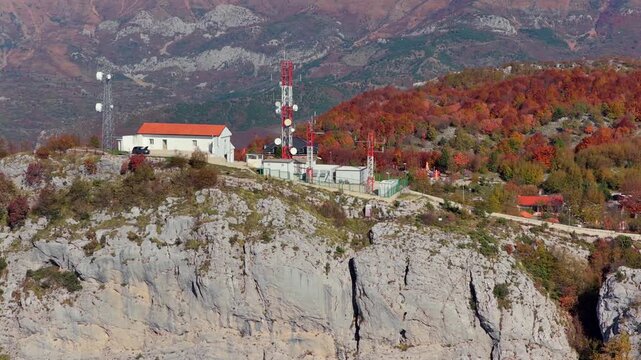 Aerial video of Sari Salltik viewpoint with communication towers, restaurants, and autumn forest on Kruj&euml; Mountain.
