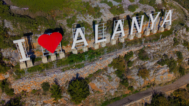 Aerial view of Alanya city hillside with big letters sign