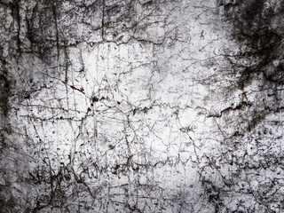 Obraz premium Grunge abstract background with cracked concrete surface, dark stains, scratches, and aged distressed texture, suitable for industrial, urban, or dramatic design use.