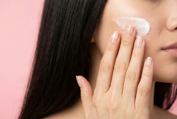 Beauty Enthusiast Carefully Testing Facial Cream With Practiced Elegance