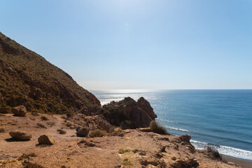 A beautiful blue ocean with a rocky cliff in the background