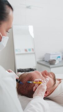 Alopecia. Trichologist cosmetologist making vitamin exosomes syringe injections. Man hair loss improve growth treatment regeneration dermapen microneedling. Head scalp procedure fractional mesotherapy