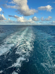 The churning blue water of a cruise ship wake on the Atlantic Ocean.