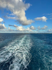 The churning blue water of a cruise ship wake on the Atlantic Ocean.