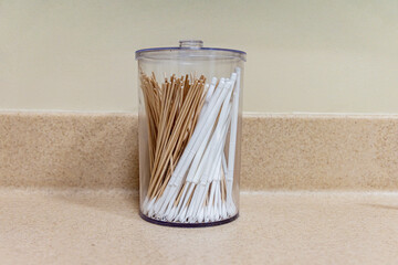 A container with cotton tipped applicators at a medical office