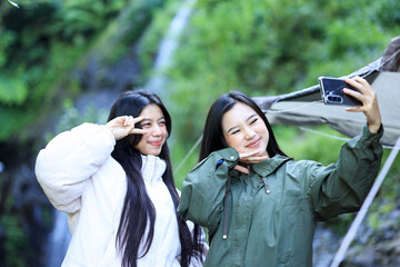 Two Asian Young Female Camper Taking Selfie on Smartphone