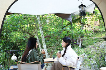 Asian Young Woman Sitting in front of Camping Glamping Tent