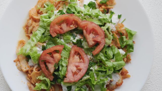 Close-Up of Chicken Kapsalon with Turkish Doner on White Plate
