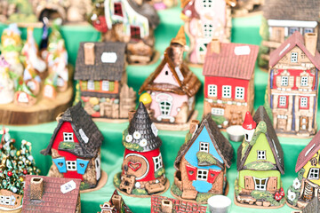 Vibrant collection of handmade ceramic miniature houses displaye