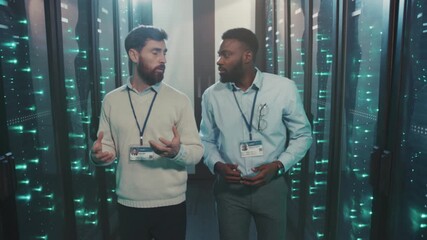 Tech team collaborates, Skilled technicians navigate server hall conducting maintenance inspections collectively