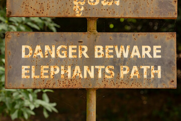 Rusty sign indicating danger, elephants on the road, in Cambodia, inside Angkor, near Siem Reap