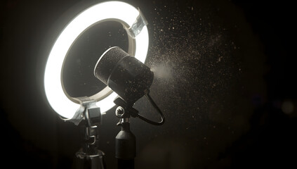 Close-up shot of a microphone with a ring light on a stand against a dark background with dust particles, conveying a tech aesthetics for editorial tech use.