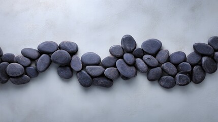A collection of smooth gray stones arranged on a textured surface