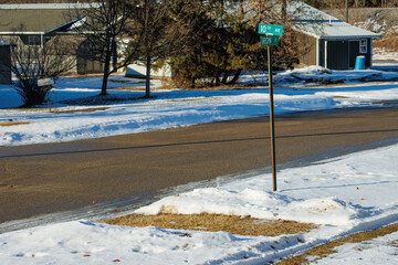 Wintertime along a snow-lined street in a residential neighborhood