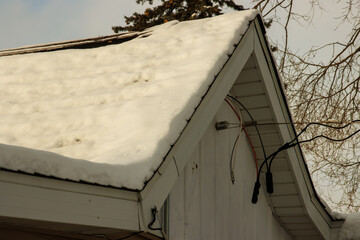 Electrical connections on a snow-covered house in winter