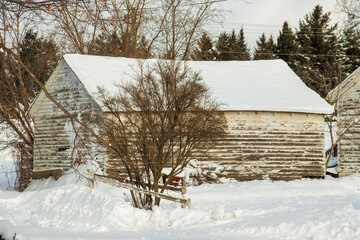 An old wooden garage in the snow