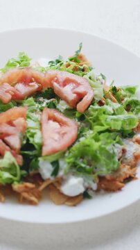 Close-Up of Chicken Kapsalon with Turkish Doner on White Plate
