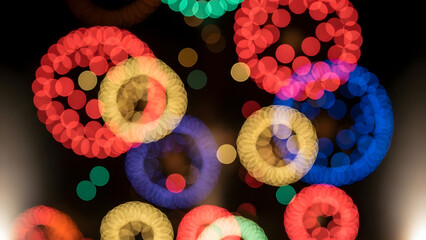 Colorful bokeh lights in festive circular patterns on dark background