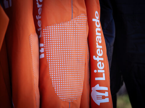 GRAZ, AUSTRIA - SEPTEMBER 20, 2025: detail of an orange Lieferando delivery jacket showing the logo in graz. Part of Just Eat, Lieferando is an austrian food delivery service.