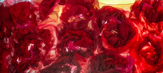 abstract background with red translucent fabric in the shape of flowers