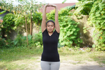 Woman Performing Overhead Arm Stretch for a Full Body Warmup