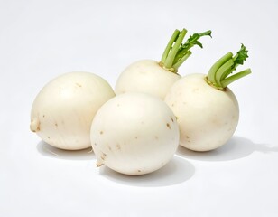 Four white, round vegetables, each with green leafy tops, isolated on white