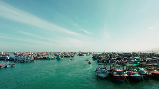Drone Flyover of Peruvian Fishing Boats Sailing at Sea, Ilo Peru.  Peruvian fishing boat sailing into the ocean and moving among many other artisanal fisherman boats. Aerial view fishing industry