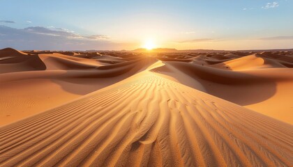 Golden sunset over vast desert dunes with rippled sand textures.