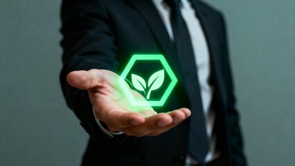 Businessman holding glowing green leaf icon