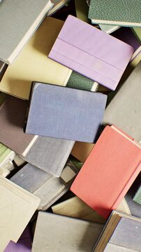 Camera High angle Rotation stack of books. 3D animation. 4K. Vertical.