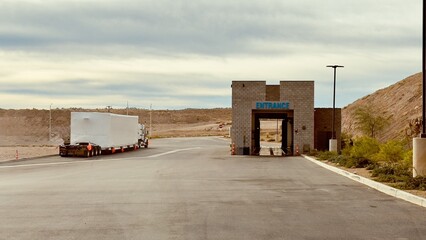 Oversize Semi-Truck Parked at Truck Wash with Nevada Sandy Mountains Background. 
