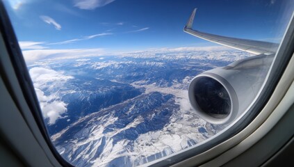 Aerial view of snow-capped mountains from an airplane window