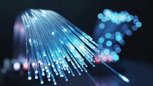 Close up of glowing blue optical fiber cables transmitting data for high speed internet concept and global communication network