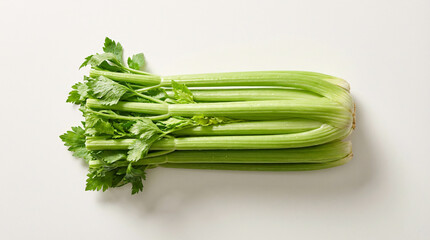 Green celery stalks with vibrant leaves, neatly arranged on a clean white background, viewed from directly above.