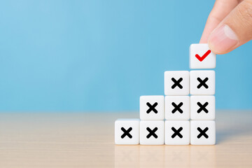 Hand choose dice stack with check mark and cross symbol for customer survey service and feedback.