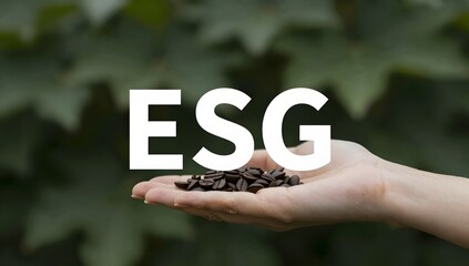 Coffee beans are held in the palm of hand with esg letters overlayed on the top