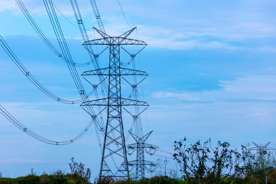 Photograph of a large electricity Transmission Tower set against a vibrant blue sky in the town of Kemps Creek in New South Wales, Australia.