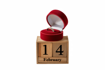 Diamond engagement ring presented in a red velvet box resting on a February fourteenth calendar on transparent background