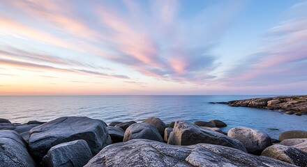 Rocky Coastline at Sunset with Pastel Colored Clouds Over the Ocean Keywords: rocks, coastline, ocean, sea, sunset, sky, clouds, pastel, pink, blue